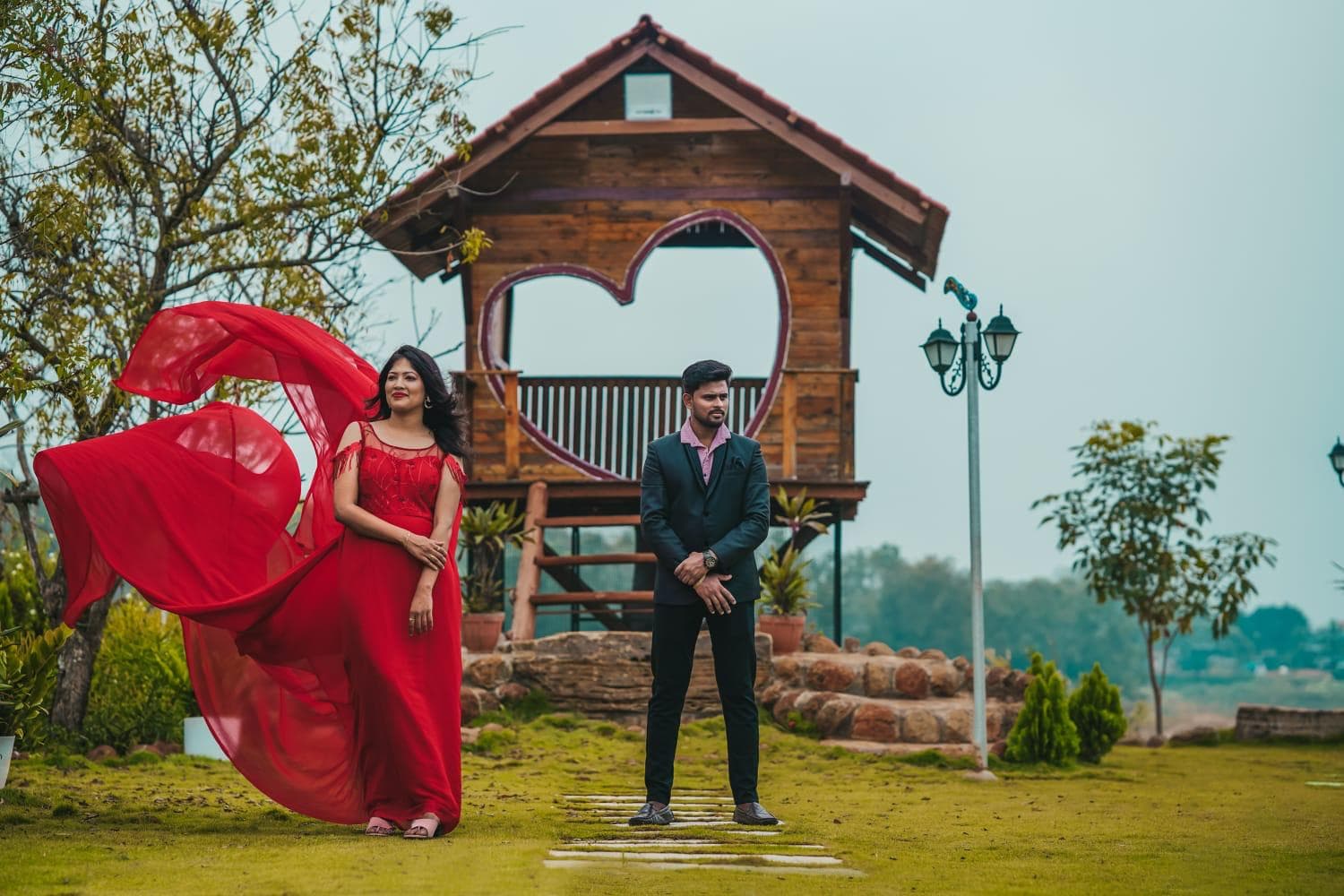 A couple before the heart-window treehouse