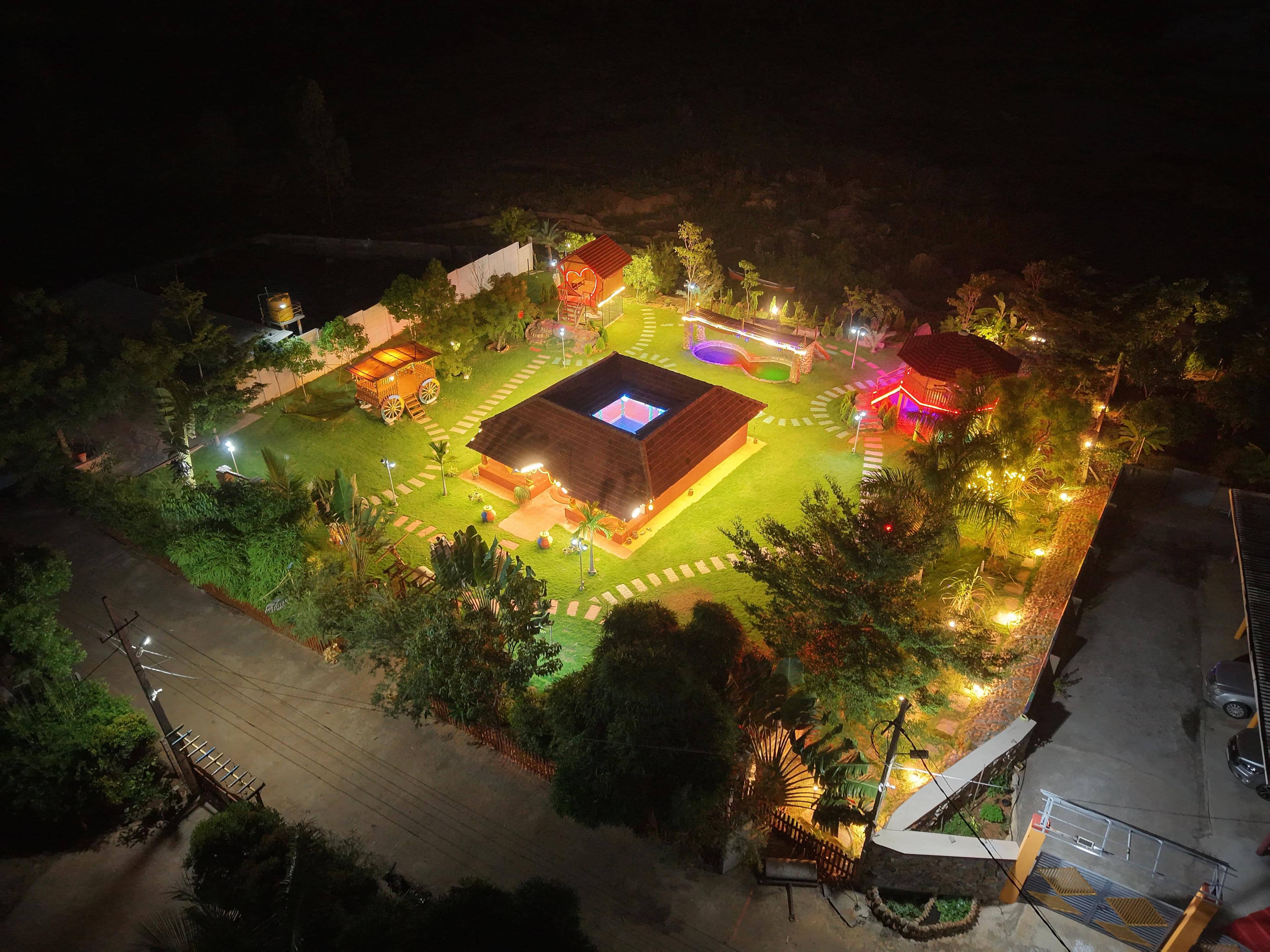 Vintage Farms lit up warmly at night, seen from above
