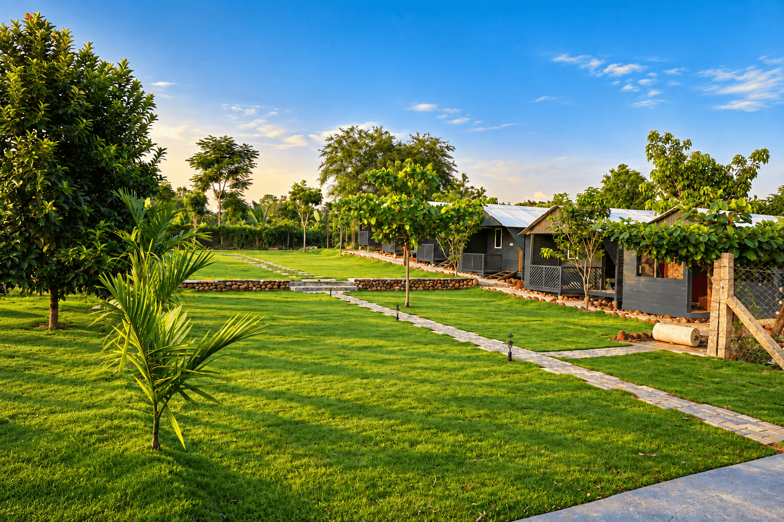 The wide lawn and row of cottages under a clear sky