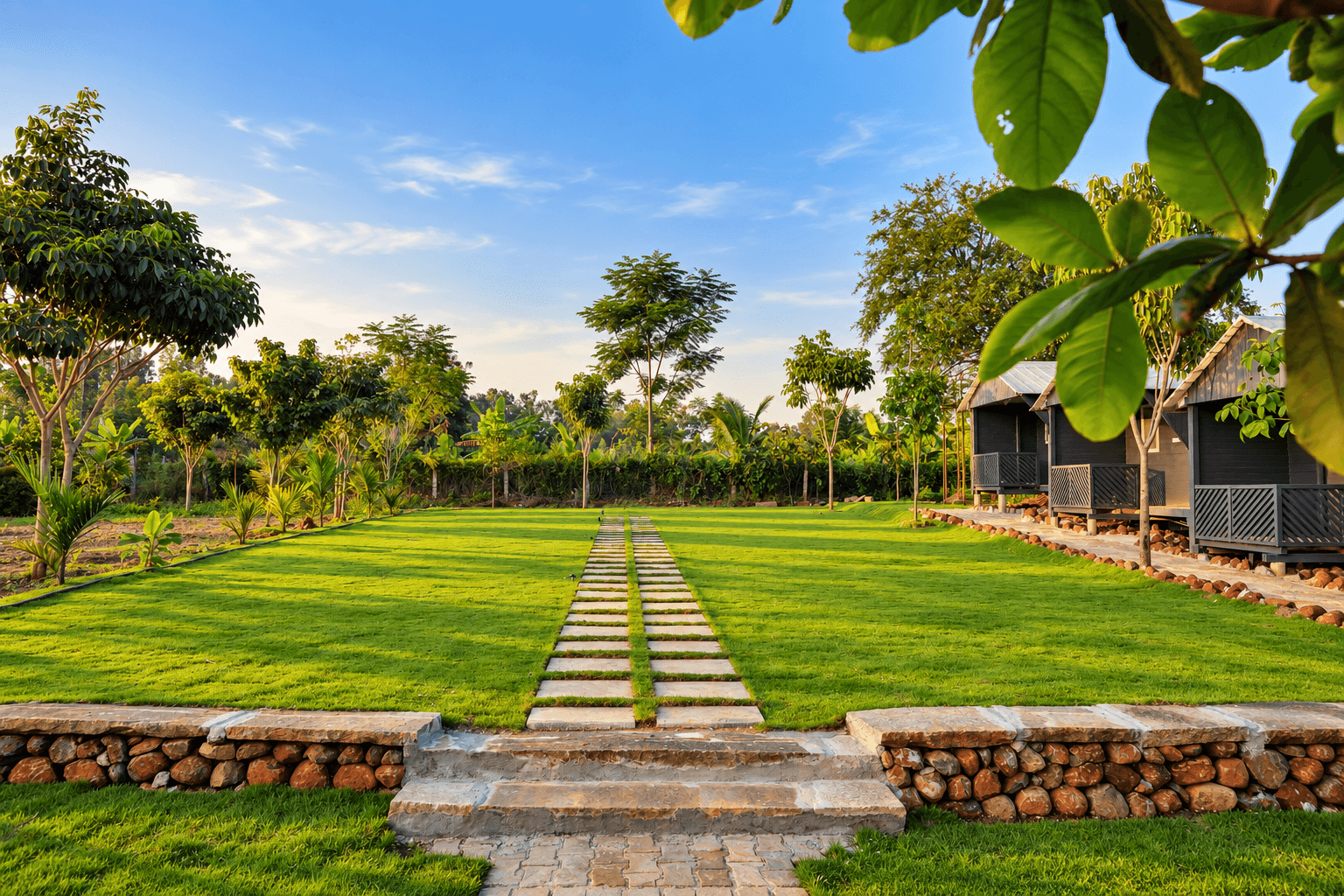 Stone steps up to the main lawn, framed by leaves